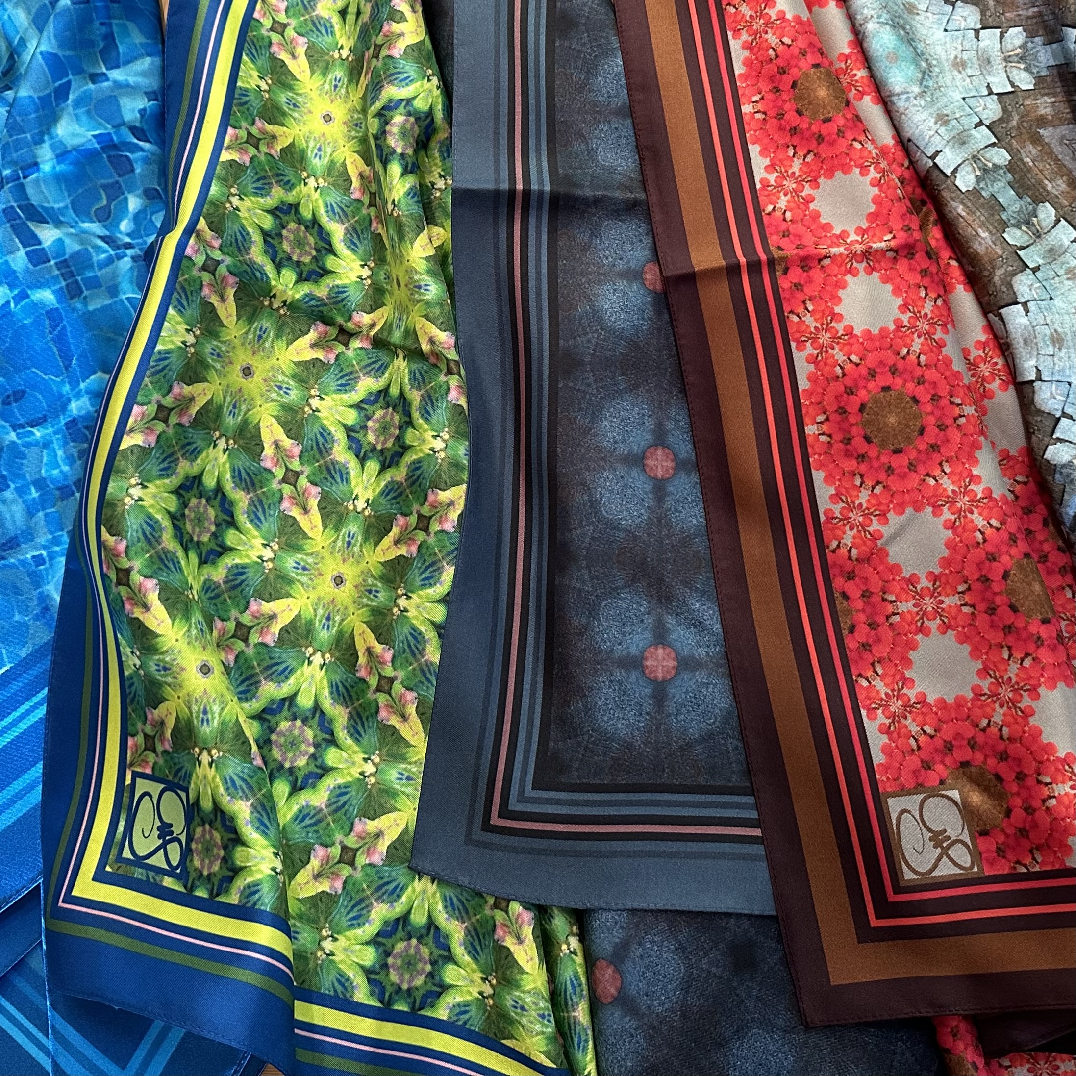 Five fabric patterns printed on silk twill